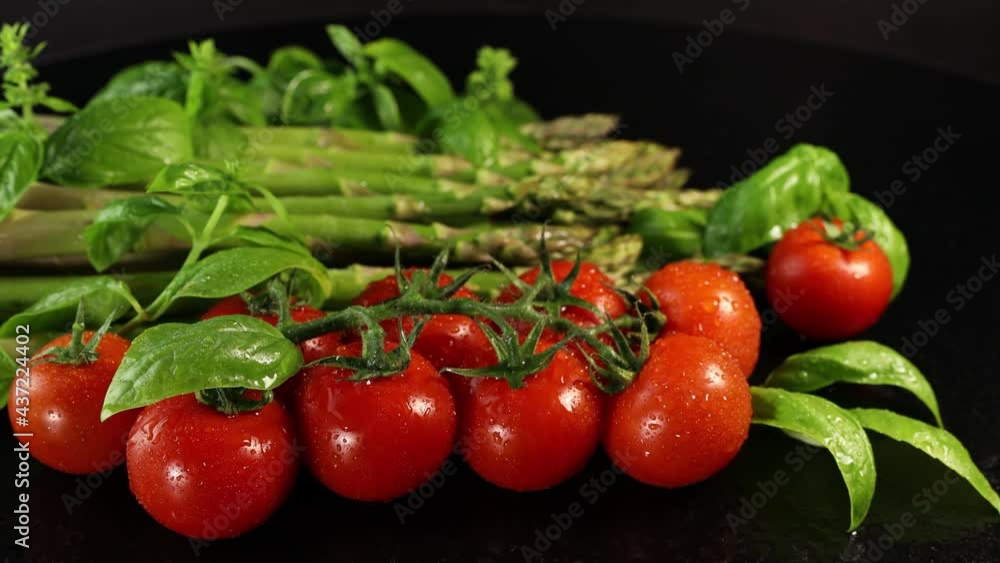Cherry tomatoes, green basil leaves and asparagus Cherry tomatoes, green basil leaves and asparagus