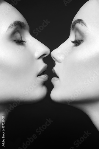 Photo Two Beautiful Girls kiss. Lovely Couple