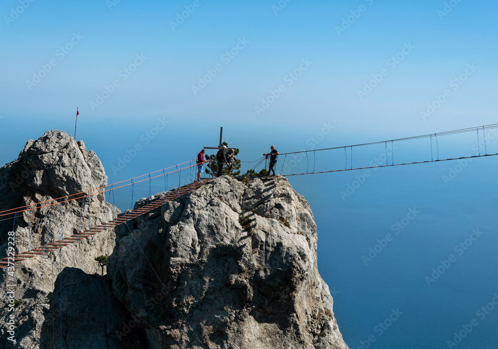 Obraz premium A young man is at the top of Mount Ai-Petri on a sunny summer day. The concept of tourism, extreme .