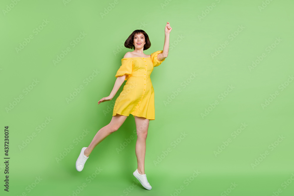 Full length photo of charming positive young woman hold hands catch umbrella isolated on green color background Full length photo of charming positive young woman hold hands catch umbrella isolated on green color background