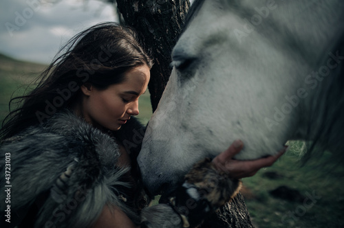 Photography Portrait of woman in image of warrior amazon with her horse.
