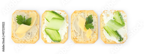 Delicious crackers with humus and cheese on white background, top view