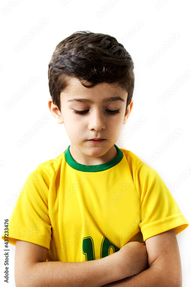 Brazilian boy, soccer player and fan, celebrates making a gesture with his hands over white background. Sports fan cherring. Brazilian boy, soccer player and fan, celebrates making a gesture with his hands over white background. Sports fan cherring.