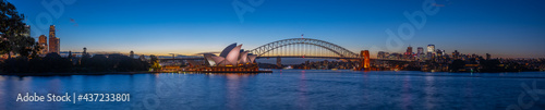Panoramic night view of Sydney Harbour a full blood moon night and CBD buildings on the foreshore in NSW Australia