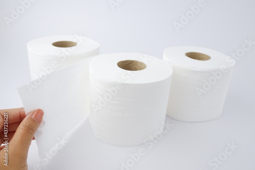 Close-up of toilet paper, tissue paper with a woman's hand holding it, isolated from on White background
