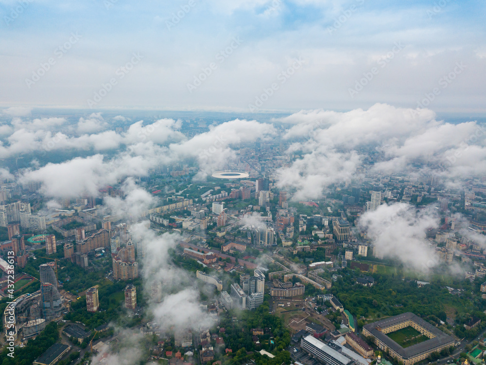 High flight above the clouds in Kiev. Spring morning. Aerial high view.