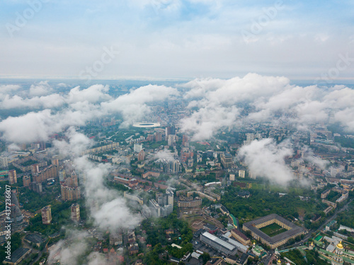 High flight above the clouds in Kiev. Spring morning. Aerial high view.