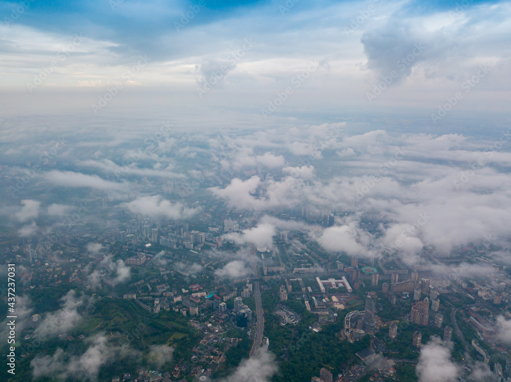 Fototapeta premium High flight above the clouds in Kiev. Spring morning. Aerial high view.