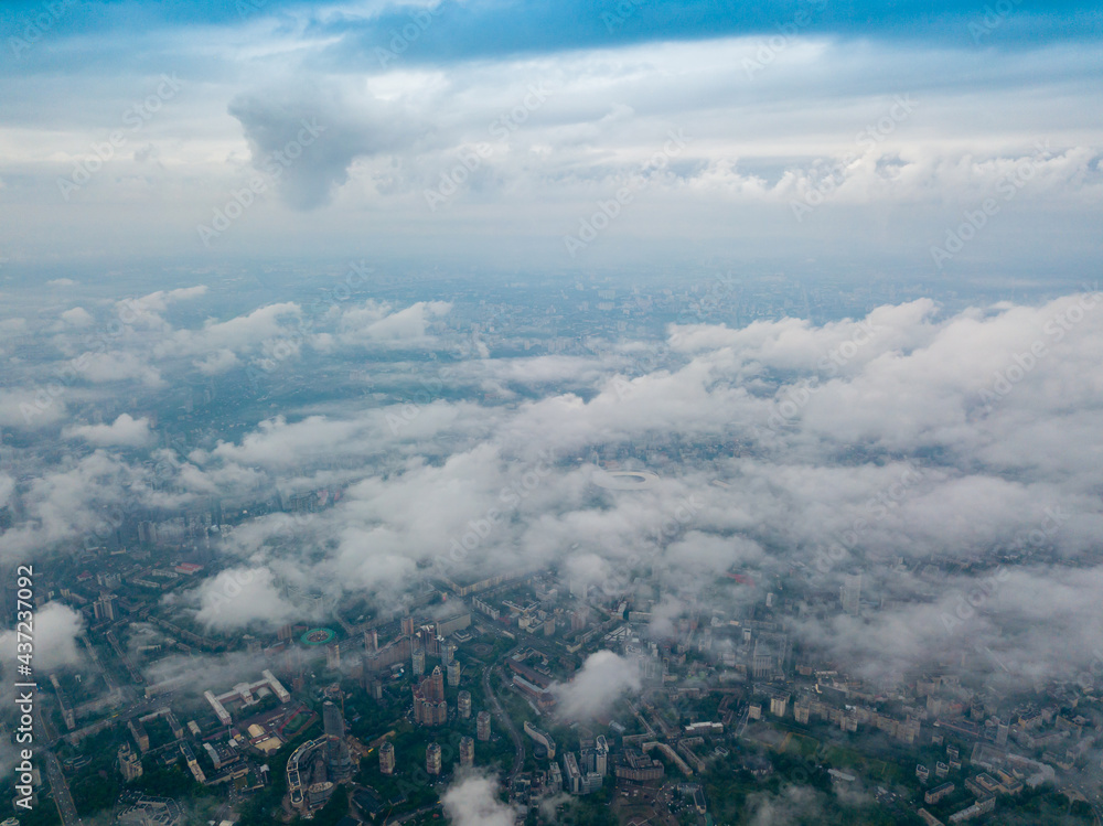 Fototapeta premium High flight above the clouds in Kiev. Spring morning. Aerial high view.