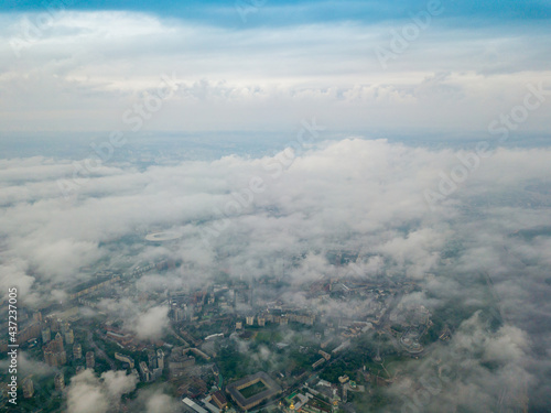 High flight above the clouds in Kiev. Spring morning. Aerial high view. © Sergey