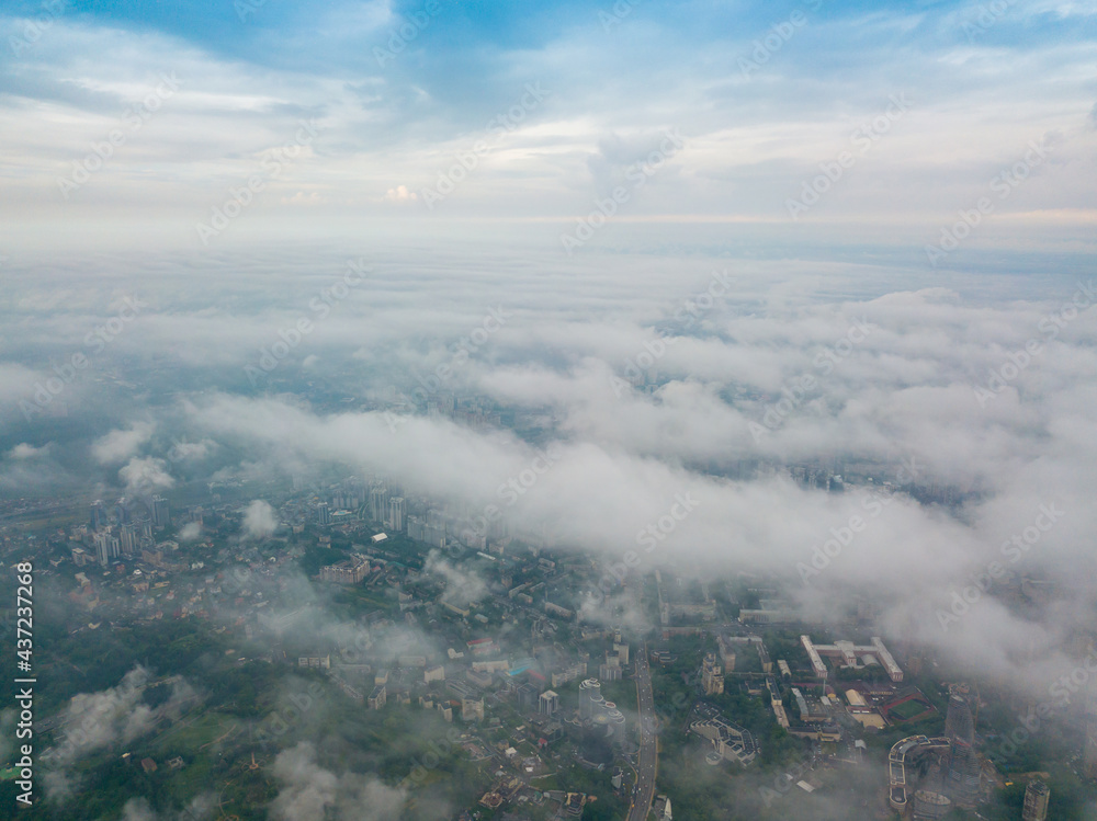 Fototapeta premium High flight above the clouds in Kiev. Spring morning. Aerial high view.