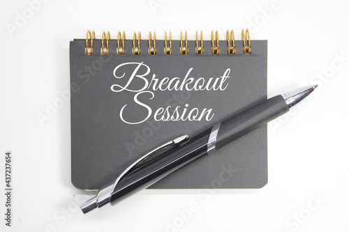 фотографія notebook and pen with the word breakout session