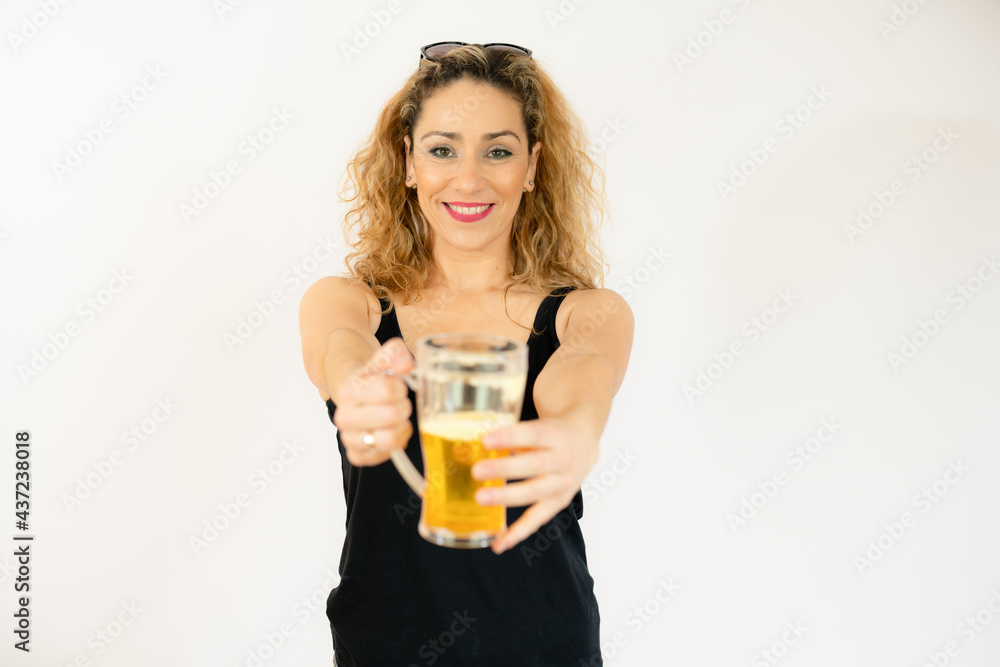 Smiling woman holding beer jar isolated over white background. Smiling woman holding beer jar isolated over white background.