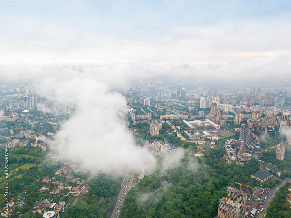 High flight above the clouds in Kiev. Spring morning. Aerial high view.