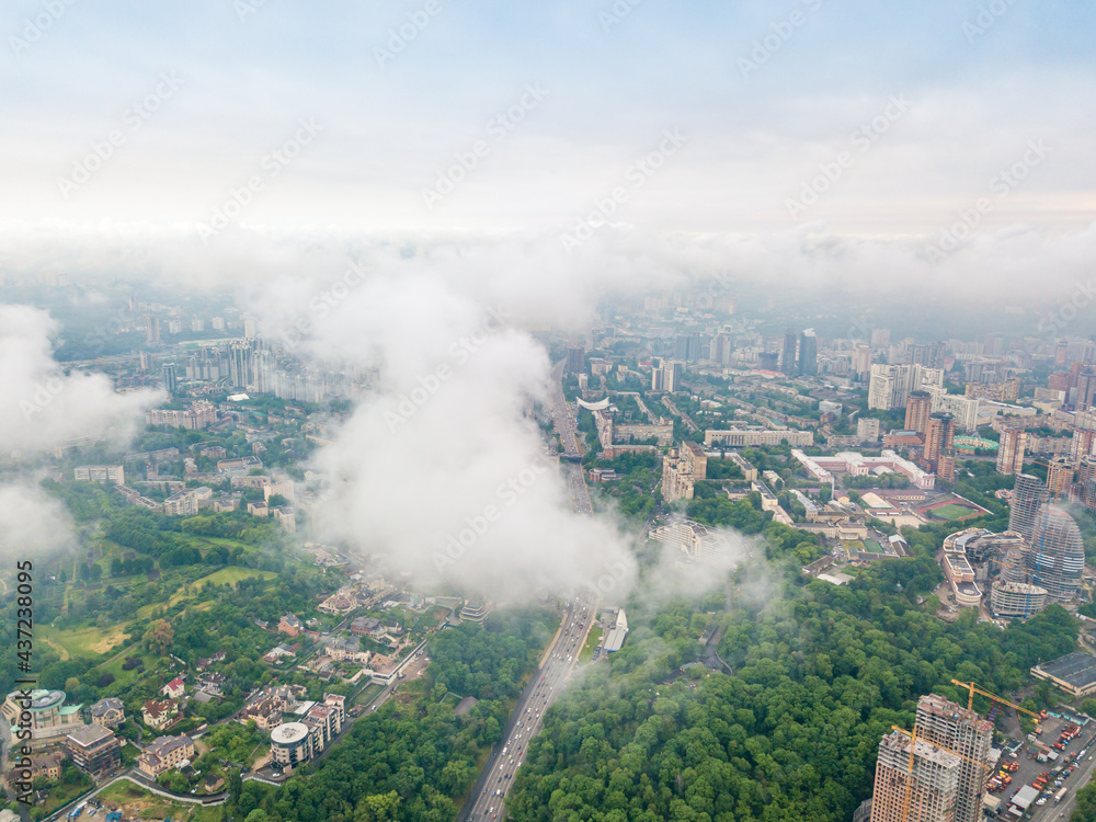 High flight above the clouds in Kiev. Spring morning. Aerial high view.