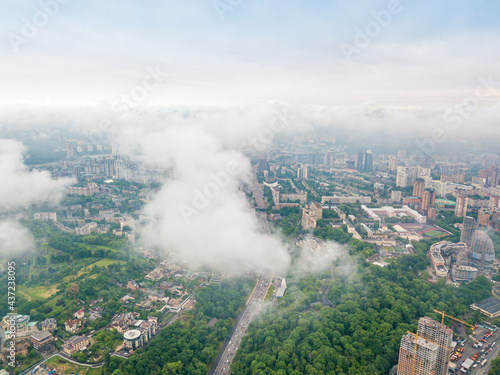 High flight above the clouds in Kiev. Spring morning. Aerial high view. © Sergey