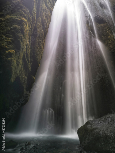 Vertical shot of Gljufrabui, a secret waterfall hidden in a cave