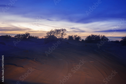 night extreme travel in Sahara huge sand dunes in sunset