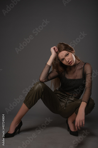 Fashion girl posing on grey background. Isolated