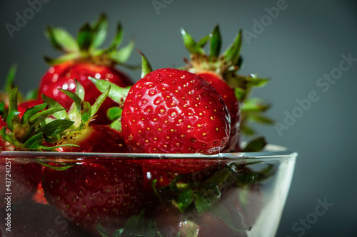 Картината върху платно Fresh strawberries in a bowl with background