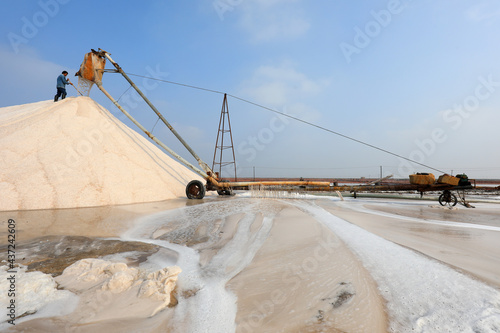 Raw salt production equipment in operation in a saltworks, North China
