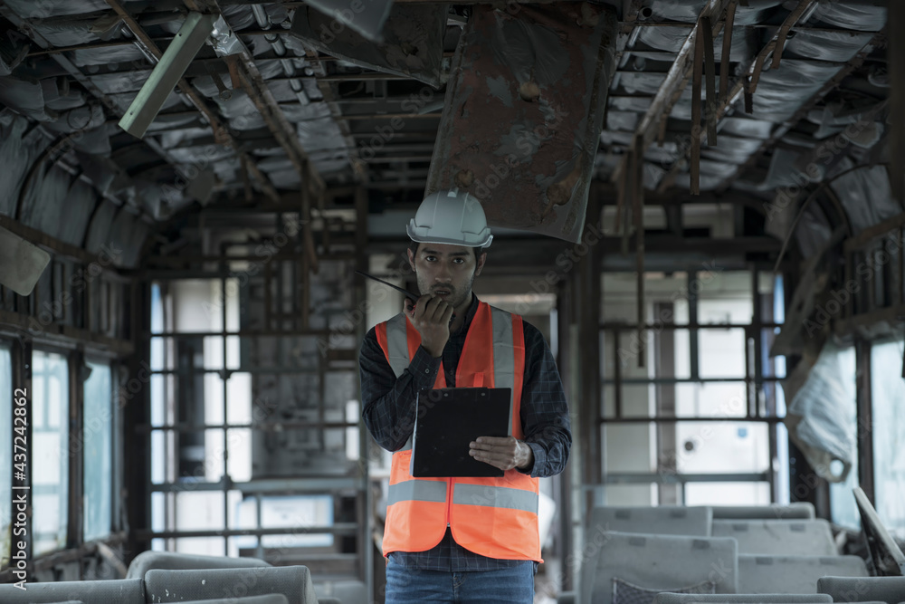 Fototapeta premium Workers are checking for damage. Damaged and used train passenger containers Communication tools to report to the controller