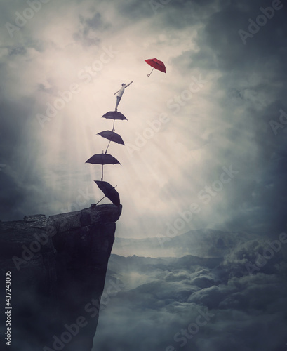 Fotografiet Surreal adventure, epic scene with a determined man climbing an improvised stairway of umbrellas, decided to reach a different one
