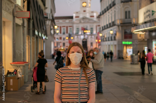 Prevention of coronavirus outbreak in 2020. Portrait of young European woman wearing a mask in the city street. Medical mask. FFP2 mask Prevent pollution and disease concept. © shakethatshit.com