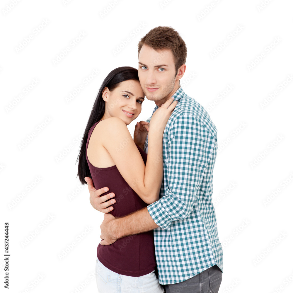 Happy young couple with white perfect smile in summer clothing embracing and looking camera on white background Happy young couple with white perfect smile in summer clothing embracing and looking camera on white background