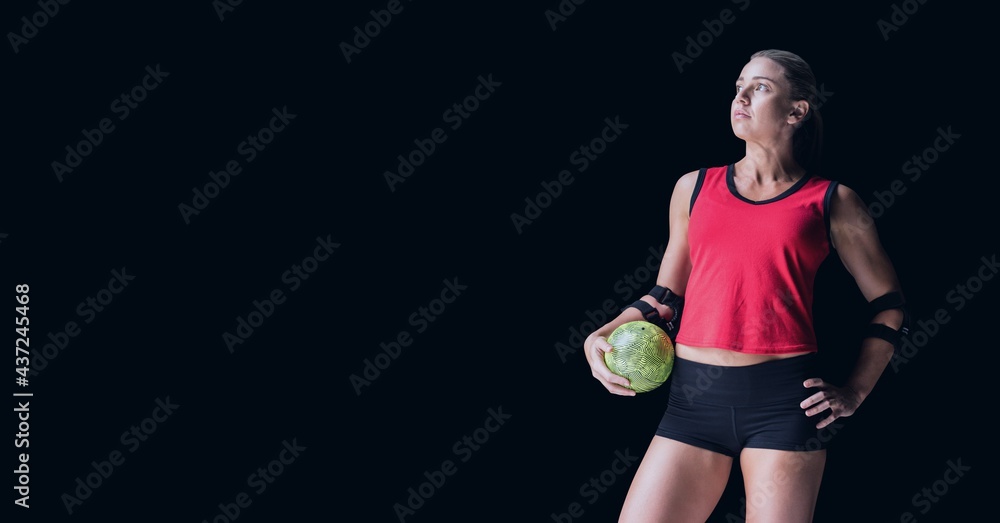 Composition of caucasian female handball player holding ball with copy space on black background