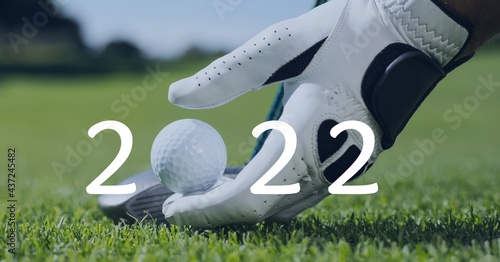 Composition of 2022 number with golf ball placed on golf course
