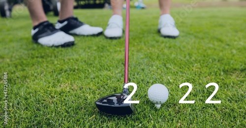 Composition of 2022 number with golf ball and golf club on golf course