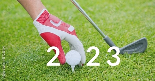 Composition of 2023 number with golf ball placed on golf course