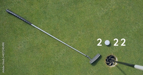 Composition of 2022 number with golf ball and golf club on golf course