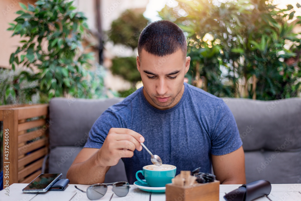 Cool young man drinking coffee in the city Cool young man drinking coffee in the city