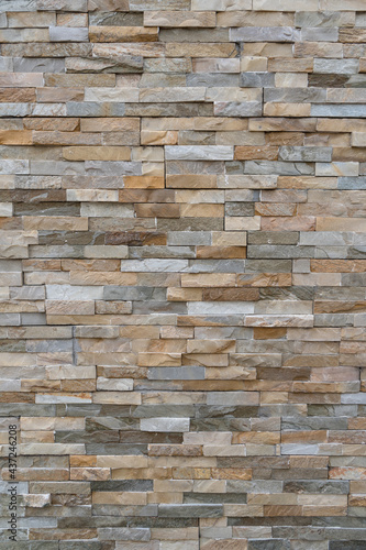 Vertical shot of modern stone wall. Texture wallpaper background.