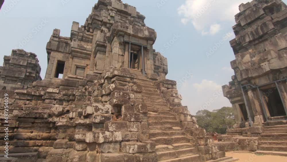 Stone ruins at Angkor Wat temple complex, Siem Reap, Cambodia. Tilt up shot Stone ruins at Angkor Wat temple complex, Siem Reap, Cambodia. Tilt up shot