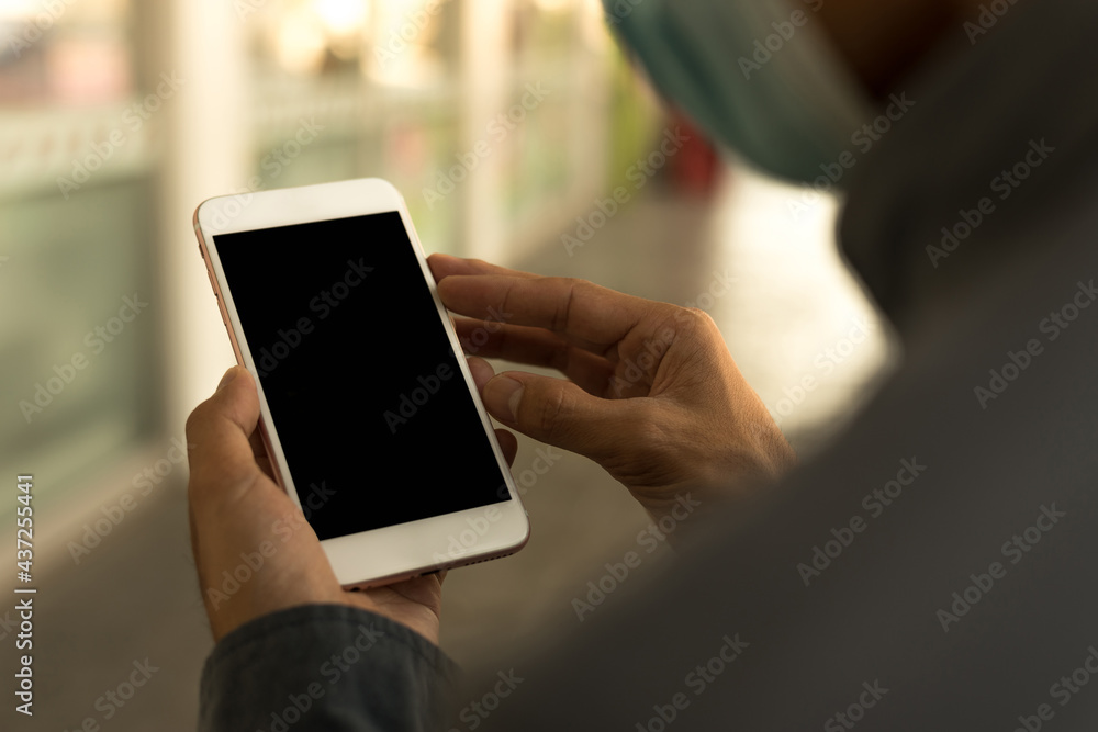 Men's hands use a smartphone for online shopping, social networking, or remote work. Close up image. Men's hands use a smartphone for online shopping, social networking, or remote work. Close up image.