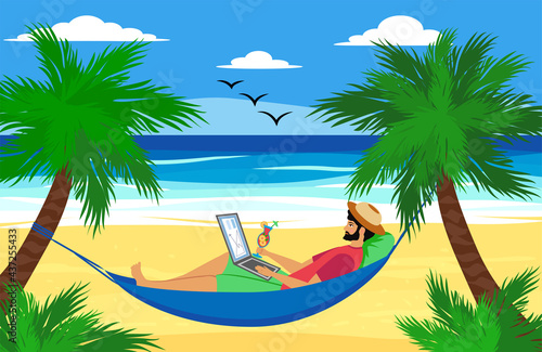 Man lying on a hammock with a laptop with a tropical cocktail. Freelancer and palms, remote work