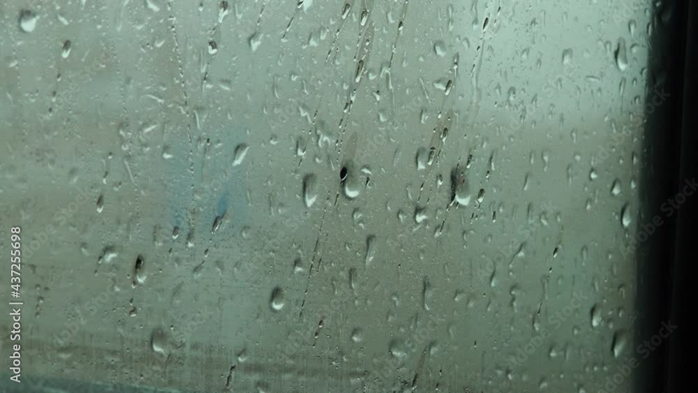 Flowing down water drops on glass. raindrops on the window, flow down. fall Flowing down water drops on glass. raindrops on the window, flow down. fall
