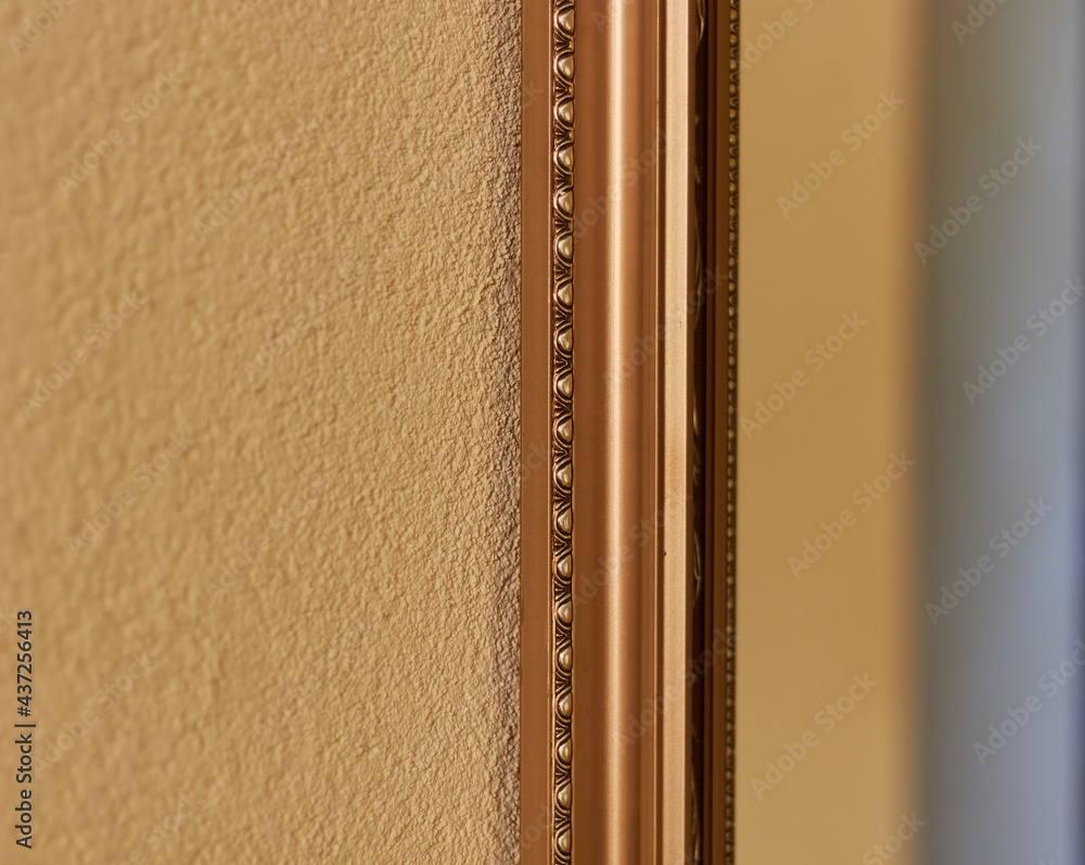 Golden part of the mirror frame. Golden part of the mirror frame.