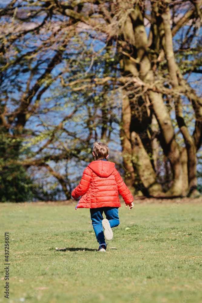 child running in park in Spring child running in park in Spring