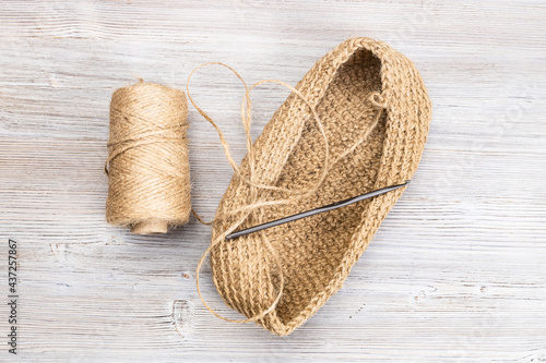 spool of hemp twine and hand-knitted bottom of bag