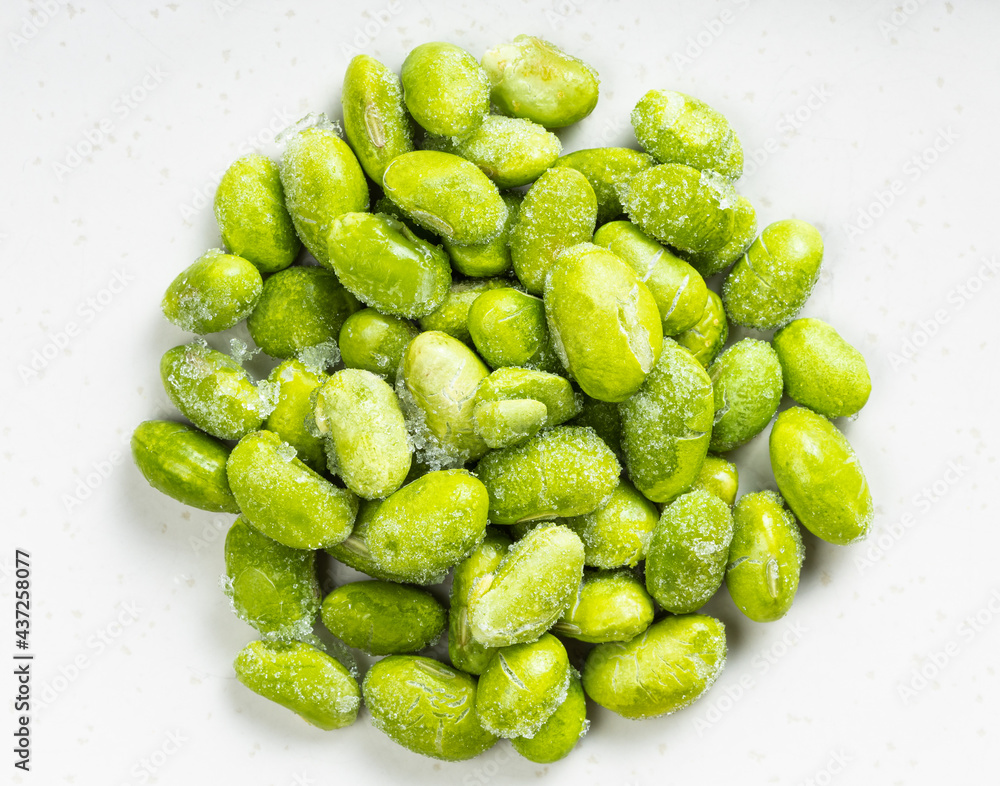 pile of frozen unripe soybeans close up on gray