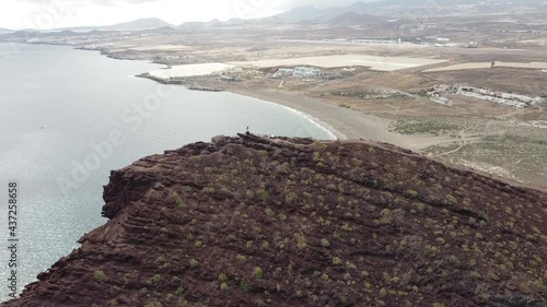 View of a drone from montana roja to the beach of el tejita on the canary island tenerife in the atlantic ocean (spain), with dark lava rocks photo