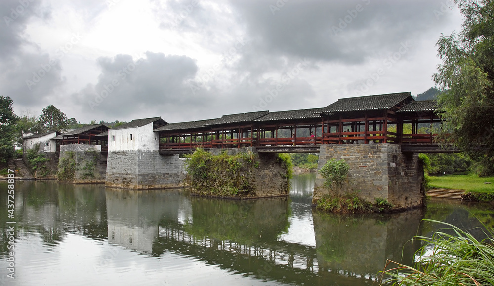 Qinghua in Wuyuan County, Jiangxi Province, China. The Qinghua Rainbow Bridge (Caihong Qiao) was a large stone beam bridge crossing the Le'an River. The Rainbow Bridge was destroyed by flood in 2020.