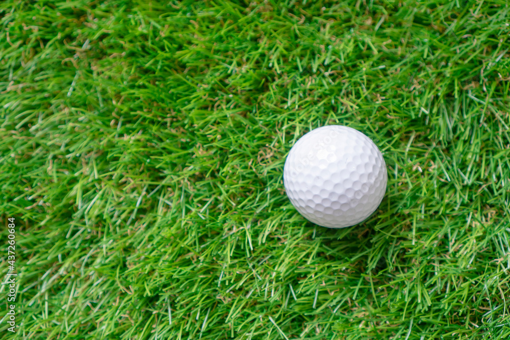 Golf ball on the green artificial grass. Top view background with copy space. Golf ball on the green artificial grass. Top view background with copy space.