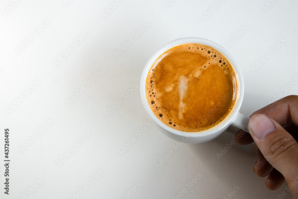 A close up of a white coffee cup with coffee on a white background. A close up of a white coffee cup with coffee on a white background.