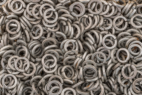 Steel grover washers for industrial manufacturing. Texture background of grover washers. photo