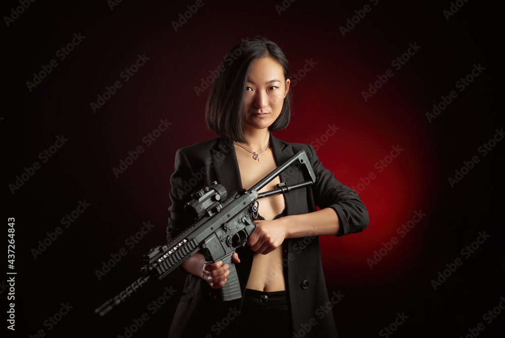 asian woman in a jacket with an automatic rifle in her hands mafia fighter